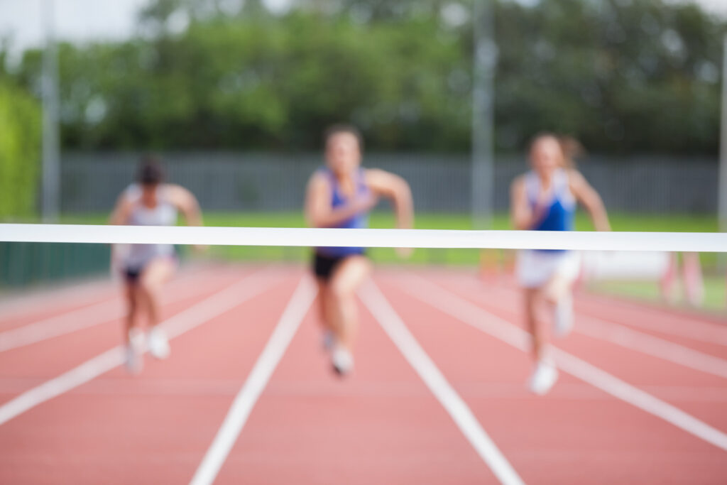 Athletes running towards finish line
